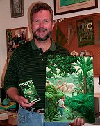 Richard Courtney holds the cover art that he painted for the book
